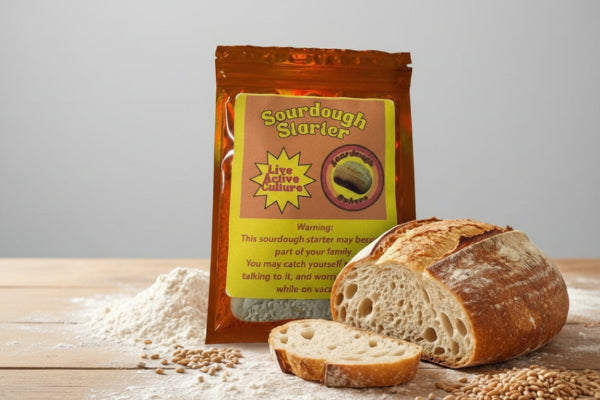 Sourdough starter package with a loaf of bread on a wooden surface, labeled 'The Heart of Artisan Bread'.